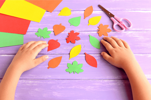 Child engaging in fall activities for preschoolers